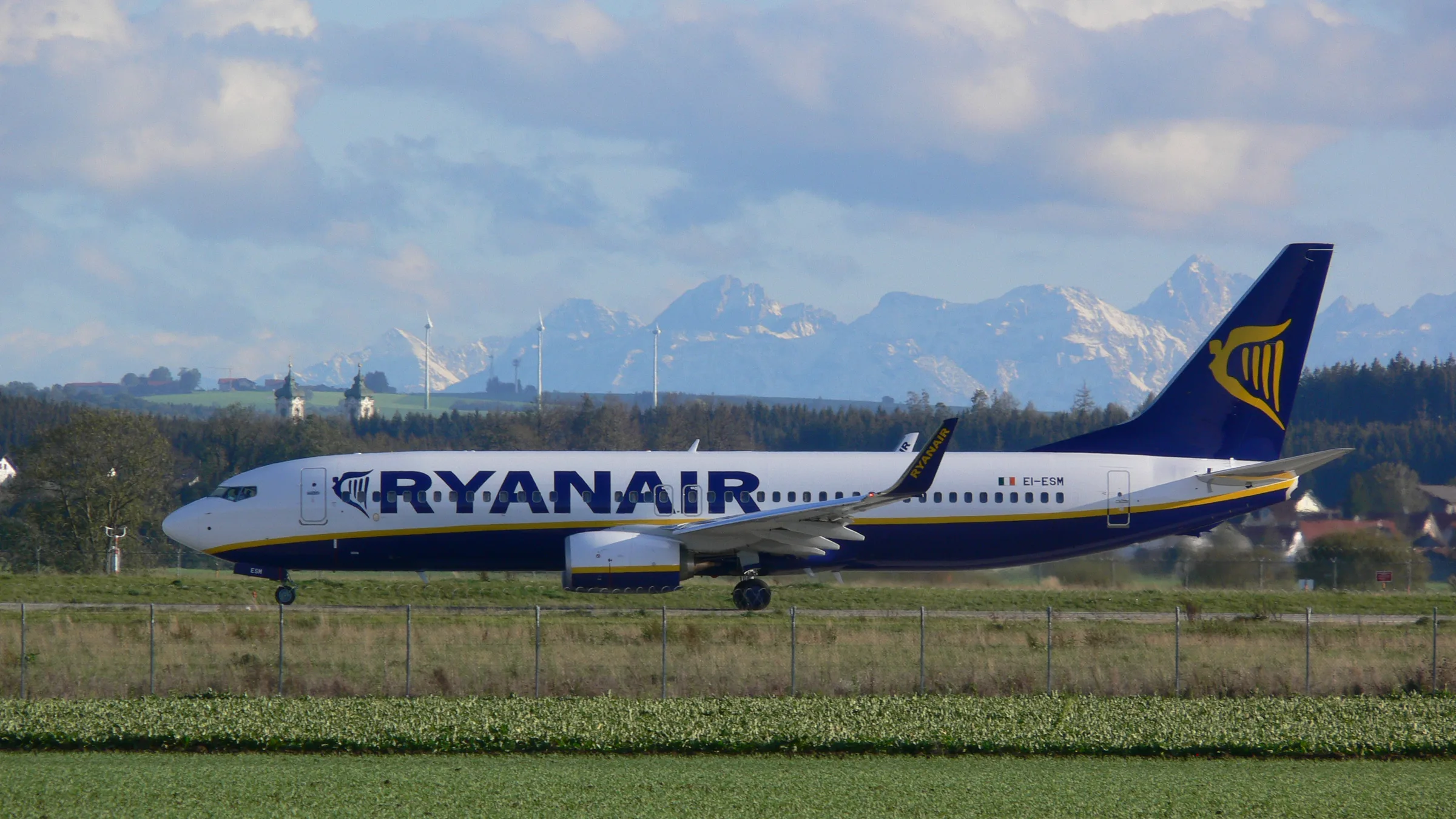 A Ryanair Boeing 737 on the apron at Memmingen Airport, the Allgäu Alps on the horizon