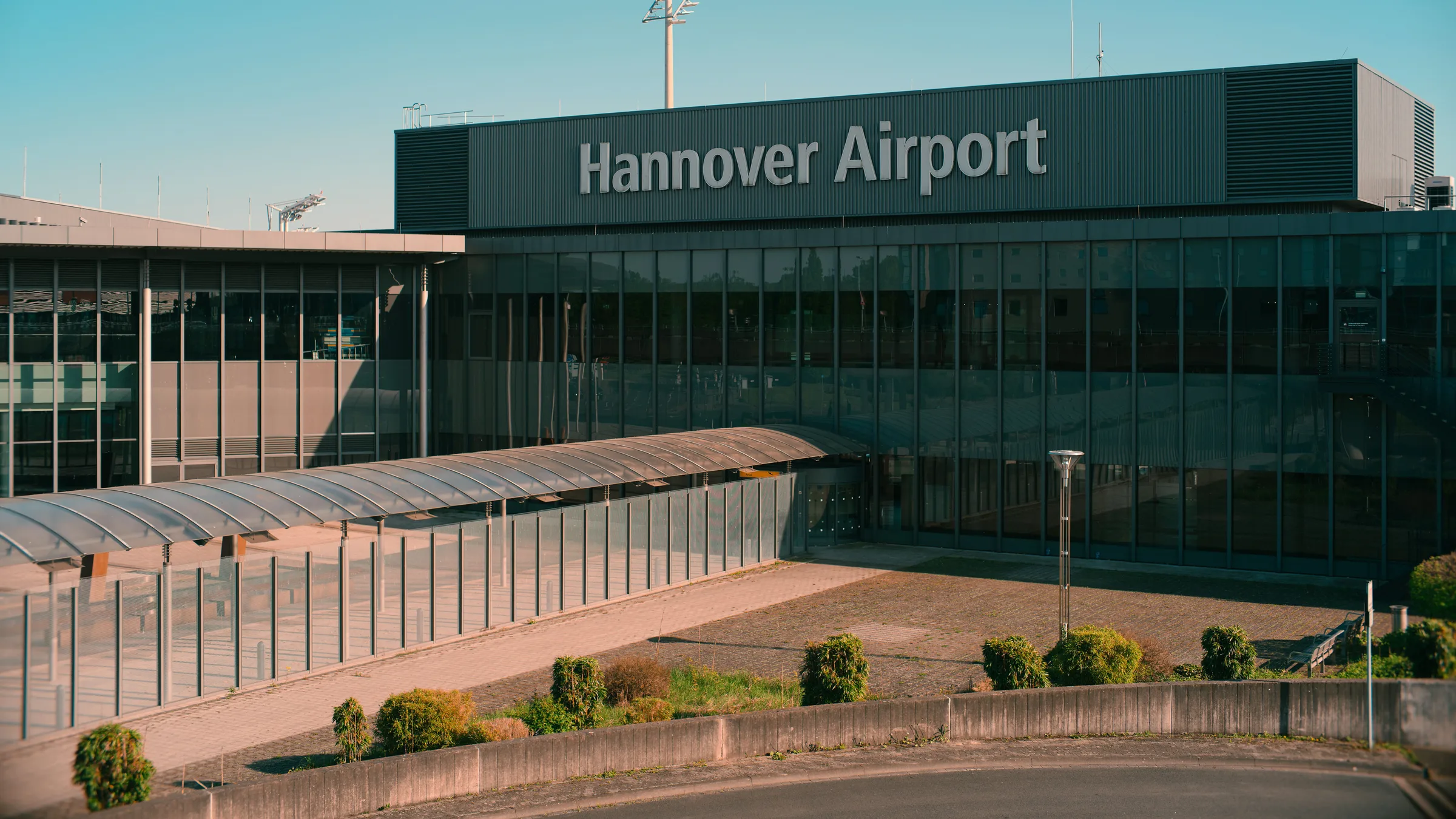 The terminal frontage at Hannover Airport under a clear sky