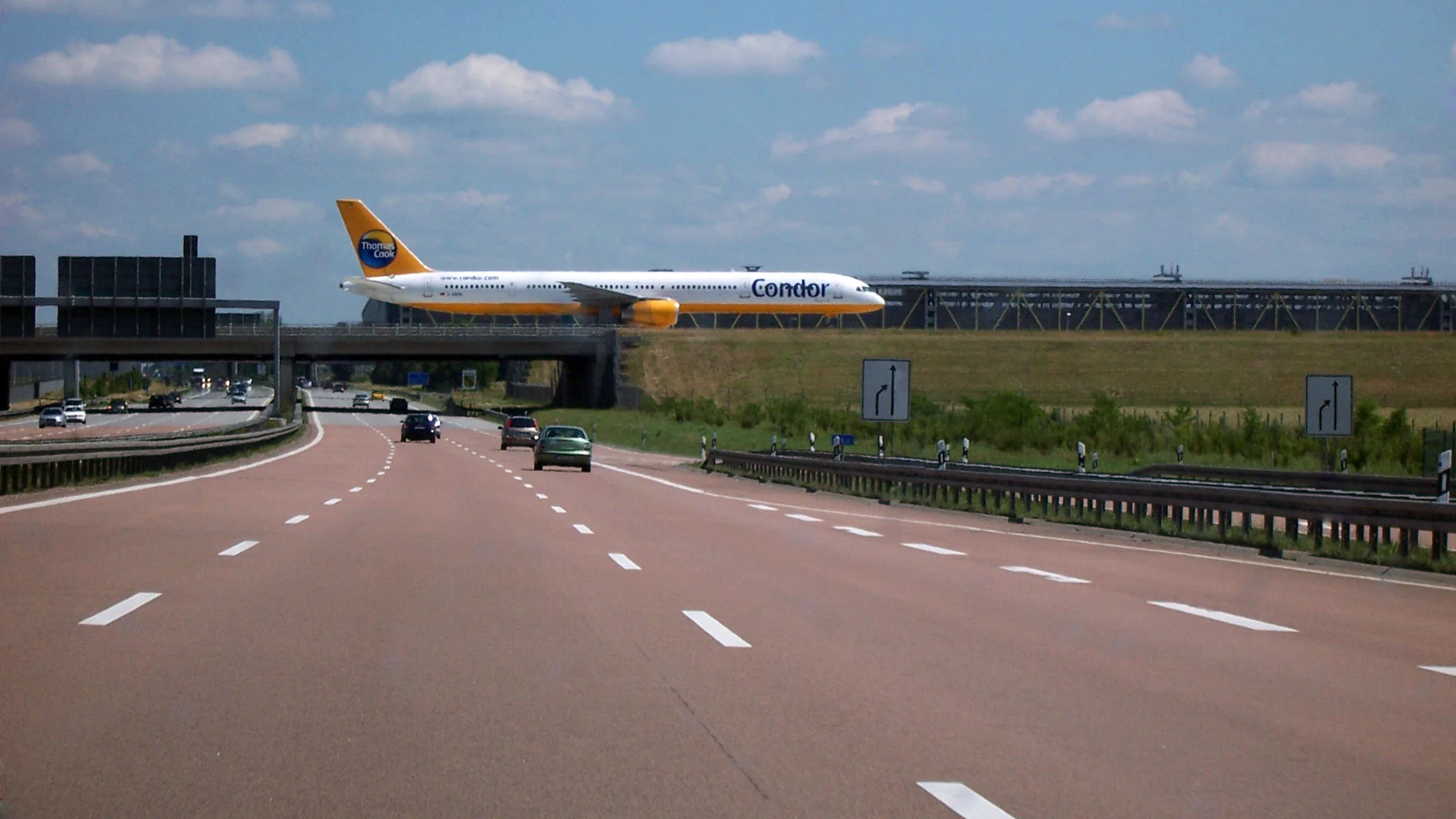 The Leipzig/Halle Airport terminal bridge spanning the autobahn, an airliner parked on top