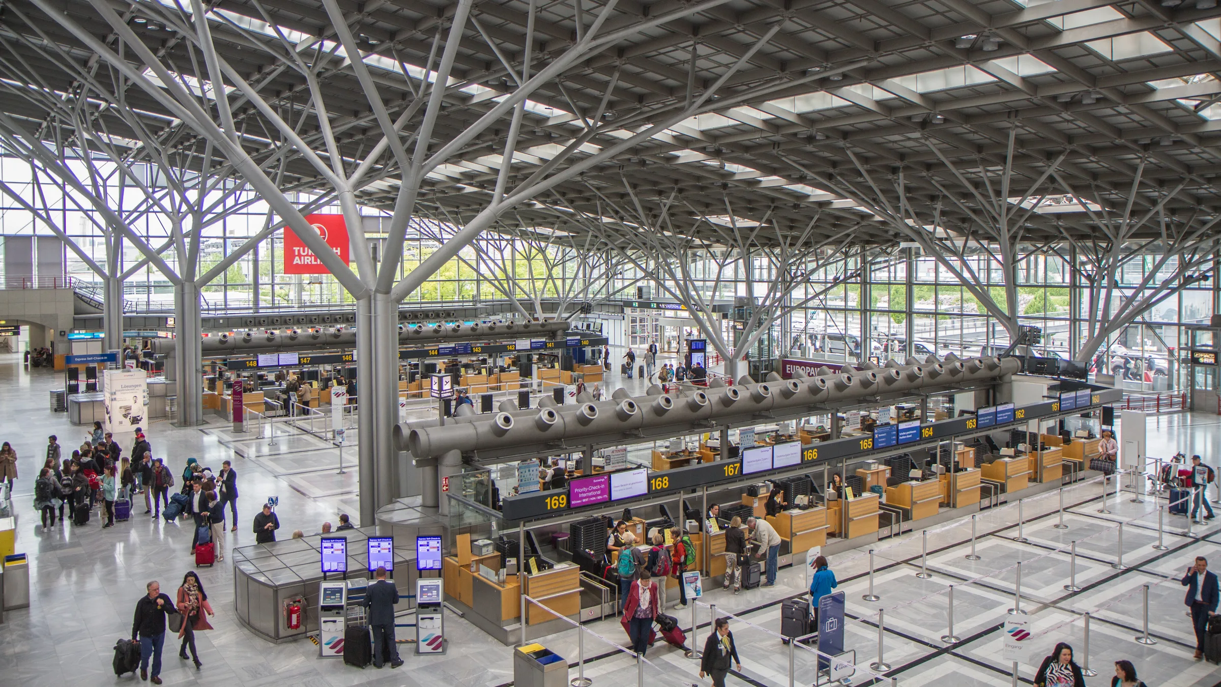 The check-in hall at Stuttgart Airport, under its tree-branch steel roof